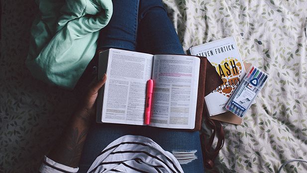 Student reading and taking notes